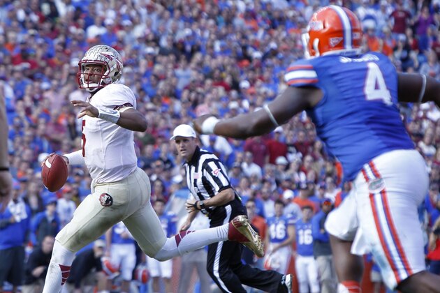 Nov 30, 2013; Gainesville, FL, USA; Florida State Seminoles quarterback Jameis Winston (5) runs out of the pocket against the Florida Gators during the second half at Ben Hill Griffin Stadium. Florida State Seminoles defeated the Florida Gators 37-7. Mandatory Credit: Kim Klement-USA TODAY Sports