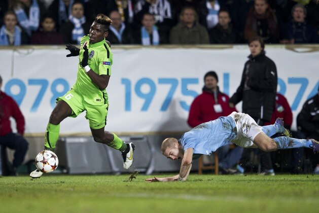 Juventus' Paul Pogba, left, controls the ball while Malmo's Anton Tinnerholm takes a fall  during their Champions League group A soccer match in Malmo, Sweden, Wednesday, Nov. 26, 2014. (AP Photo/TT, Andreas Hillergren)   SWEDEN OUT