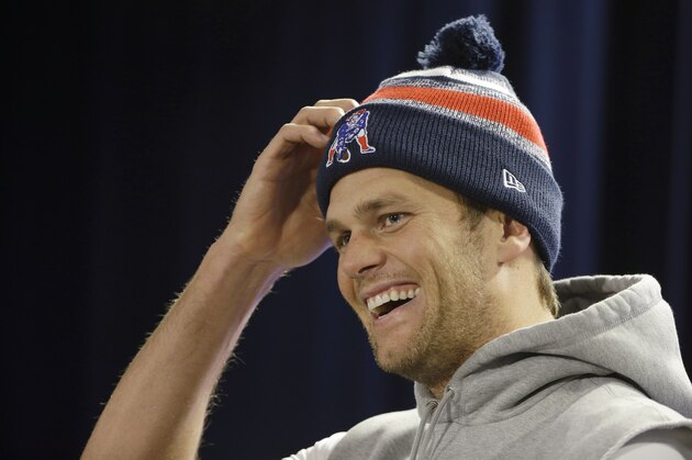 New England Patriots quarterback Tom Brady laughs as he listens to a reporter's questions during a media availability at the NFL football team's facility Wednesday, Nov. 26, 2014 in Foxborough, Mass. The Patriots will play the Green Bay Packers on Sunday in Wisconsin. (AP Photo/Stephan Savoia)