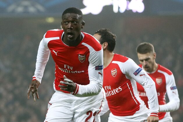 Arsenal's Yaya Sanogo celebrates scoring during the Champions League group D soccer match between Arsenal and Borussia Dortmund at the Emirates stadium in London, Wednesday, Nov. 26, 2014. (AP Photo/Alastair Grant)