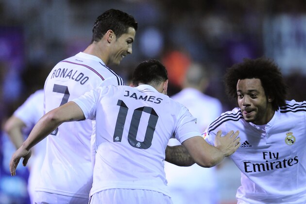 Real Madrid's James Rodriguez of Colombia, center, celebrates his goal with Cristiano Ronaldo of Portugal, left, and Marcelo of Brazil after scoring against SD Eibar, during their La Liga soccer match, at Ipurua stadium in Eibar, northern Spain, Saturday Nov. 22, 2014.  Real Madrid won 4-0. (AP Photo/Alvaro Barrientos)
