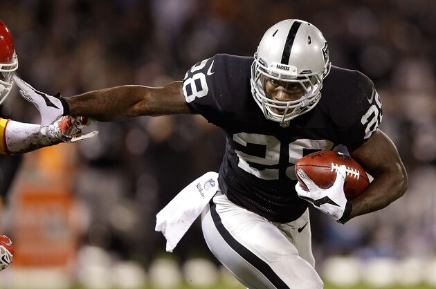 OAKLAND, CA - NOVEMBER 20: Latavius Murray #28 of the Oakland Raiders stiff arms Sean Smith #21 of the Kansas City Chiefs during the game at O.co Coliseum on November 20, 2014 in Oakland, California.  (Photo by Ezra Shaw/Getty Images)