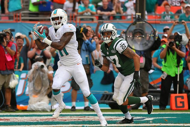 MIAMI GARDENS, FL - DECEMBER 29: Mike Wallace #11 of the Miami Dolphins catches a touchdown pass during a game  at Sun Life Stadium on December 29, 2013 in Miami Gardens, Florida.  (Photo by Mike Ehrmann/Getty Images)