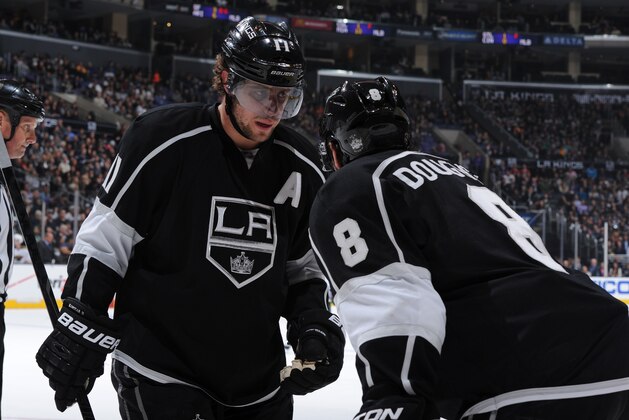 LOS ANGELES, CA - MARCH 31: Anze Kopitar #11 and Drew Doughty #8 of the Los Angeles Kings converse during a game against the Minnesota Wild at STAPLES Center on March 31, 2014 in Los Angeles, California. (Photo by Andrew D. Bernstein/NHLI via Getty Images)