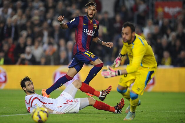 FC Barcelona's Neymar, from Brazil, second left, duels for the ball against Sevilla's Nicolas Pareja, left, during a Spanish La Liga soccer match between FC Barcelona and Sevilla,  at the Camp Nou stadium in Barcelona, Spain, Saturday, Nov. 22, 2014. (AP Photo/Manu Fernandez)