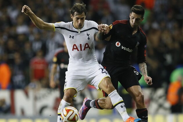 Tottenham’s Benjamin Stambouli, left, challenges for the ball with Besiktas’ Jose Sosa, during the Europa League group C soccer match between Tottenham Hotspur and Besiktas, at Tottenham's White Hart Lane stadium, in London, Thursday, Oct. 2, 2014. (AP Photo/Alastair Grant)