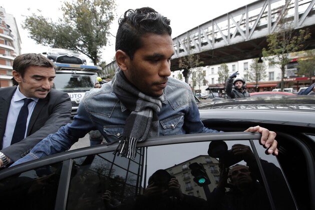 Brazilian striker Brandao and his lawyer Olivier Martin enter a taxi as they leave the French soccer federation (FFF) after appeal hearings, in Paris, Tuesday, Nov.4, 2014. Brandao was banned for six months for headbutting Paris Saint-Germain midfielder Thiago Motta and breaking his nose after a match between PSG and Bastia. (AP Photo/Francois Mori)
