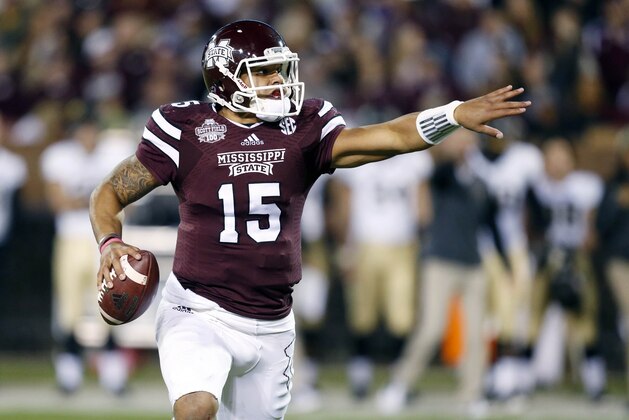 Mississippi State quarterback Dak Prescott (15) directs his blockers as he tries to find an open player in the first half of an NCAA college football game against Vanderbilt, Saturday, Nov. 22, 2014, in Starkville, Miss. (AP Photo/Rogelio V. Solis)