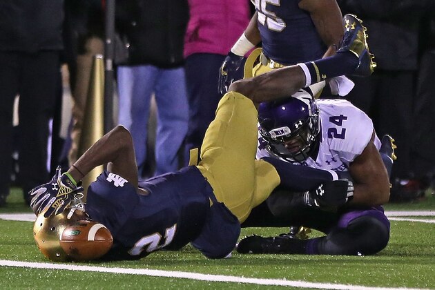 SOUTH BEND, IN - NOVEMBER 15:  Chris Brown #2 of the Notre Dame Fighting Irish fumbles just short of the goal line after being hit by Ibraheim Campbell #24 of the Northwestern Wildcats at Notre Dame Stadium on November 15, 2014 in South Bend, Indiana. Northwestern defeated Notre Dame 43-40 in overtime.  (Photo by Jonathan Daniel/Getty Images)