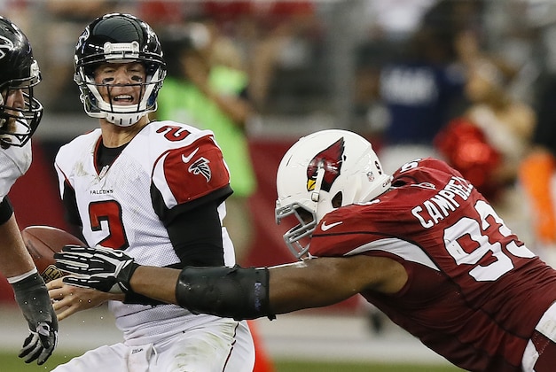 Arizona Cardinals' Calais Campbell, right, sacks Atlanta Falcons' Matt Ryan (2) during the second half in an NFL football game on Sunday Oct. 27, 2013, in Glendale, Ariz.  The Cardinals defeated the Falcons 27-13. (AP Photo/Ross D. Franklin)