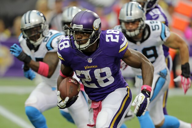Minnesota Vikings running back Adrian Peterson runs against the Carolina Panthers during the first half of an NFL football game in Minneapolis, Sunday, Oct. 13, 2013. (AP Photo/Ann Heisenfelt)