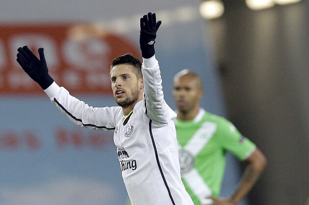 Everton's Kevin Mirallas celebrates scoring his side's 2nd goal during the Europa League Group H soccer match between VfL Wolfsburg and Everton FC at the Volkswagen Arena stadium in Wolfsburg, Germany, Thursday, Nov. 27, 2014. In the background is Wolfsburg's Naldo. (AP Photo/Michael Sohn)