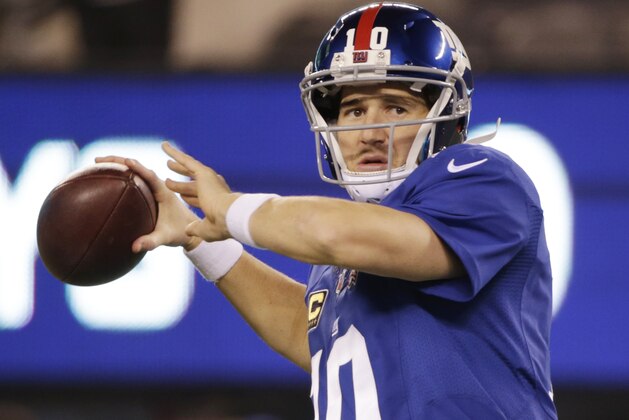 New York Giants quarterback Eli Manning (10) warms up before playing against the Dallas Cowboys in an NFL football game, Sunday, Nov. 23, 2014, in East Rutherford, N.J. (AP Photo/Julio Cortez)