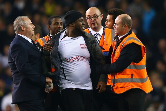 LONDON, ENGLAND - NOVEMBER 27:  Stewards apprehend  a pitch invader during the UEFA Europa League group C match between Tottenham Hotspur FC and FK Partizan at White Hart Lane on November 27, 2014 in London, United Kingdom.  (Photo by Ian Walton/Getty Images)
