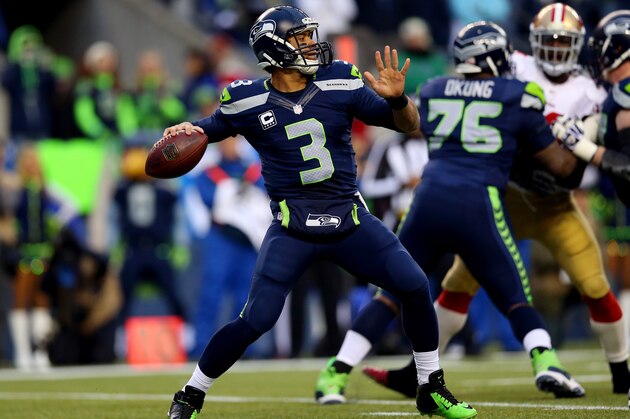 SEATTLE, WA - JANUARY 19:  Quarterback Russell Wilson #3 of the Seattle Seahawks throws the ball in the first half against the San Francisco 49ers during the 2014 NFC Championship at CenturyLink Field on January 19, 2014 in Seattle, Washington.  (Photo by Ronald Martinez/Getty Images)