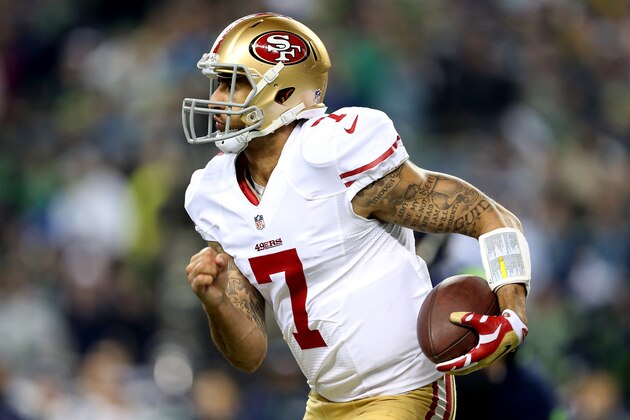 SEATTLE, WA - JANUARY 19:  Quarterback Colin Kaepernick #7 of the San Francisco 49ers runs the ball in the fourth quarter while taking on the Seattle Seahawks during the 2014 NFC Championship at CenturyLink Field on January 19, 2014 in Seattle, Washington.  (Photo by Christian Petersen/Getty Images)