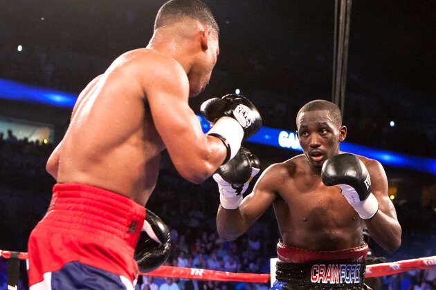 Terence Crawford, right, and Yuriorkis Gamboa face off during the WBO lightweight boxing bout Saturday, June 28, 2014, in Omaha, Neb. Crawford won the bout in the ninth round. (AP Photo/John Peterson)