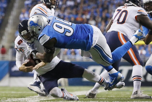 Detroit Lions defensive end Ezekiel Ansah (94) sacks Chicago Bears quarterback Jay Cutler during the second half of an NFL football game in Detroit, Thursday, Nov. 27, 2014. (AP Photo/Rick Osentoski)