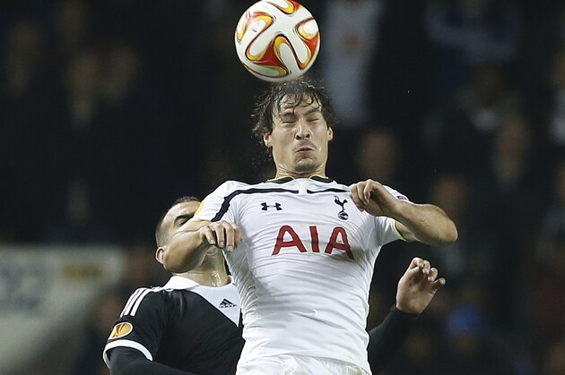 Tottenham's Benjamin Stambouli heads the ball away from Partizan Belgrade's Petar Skuletic during the Europa League group C soccer match between Tottenham Hotspur and Partizan Belgrade at White Hart Lane stadium in London, Thursday, Nov. 27, 2014 .(AP Photo/Alastair Grant)
