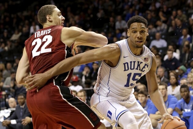 Duke's Jahlil Okafor, right, moves past Stanford's Reid Travis during the second half of an NCAA college basketball game for first place in the Coaches vs. Cancer Classic, Saturday, Nov. 22, 2014, in New York. Duke defeated Stanford 70-59. (AP Photo/Seth Weng)