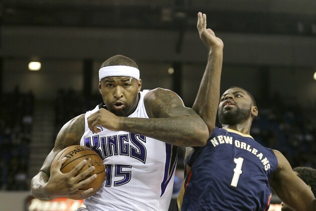 Sacramento Kings center DeMarcus Cousins, left, grabs a rebound against New Orleans Pelicans guard Tyreke Evans during the first quarter of an NBA basketball game in Sacramento, Calif., Tuesday, Nov. 18, 2014. (AP Photo/Rich Pedroncelli)