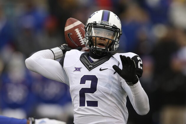FILE - In this Nov. 15, 2014, file photo, TCU quarterback Trevone Boykin (2) passes to a teammate during the first half of an NCAA college football game against Kansas in Lawrence, Kan. Boykin, the only TCU player ever with a 200-yard passing game, 100-yard receiving game and 100-yard rushing game in the same season is now focused only on being the quarterback in TCU's new up-tempo offense, with the No. 5 Horned Frogs in playoff contention and him in the Heisman conversation. (AP Photo/Orlin Wagner, File)