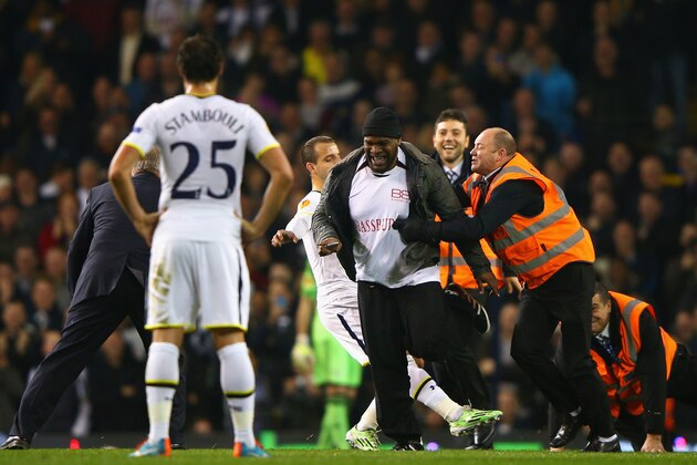 LONDON, ENGLAND - NOVEMBER 27: Roberto Soldado of Spurs attempts to tackle a pitch invader as stewards apprehend him during the UEFA Europa League group C match between Tottenham Hotspur FC and FK Partizan at White Hart Lane on November 27, 2014 in London, United Kingdom.  (Photo by Ian Walton/Getty Images)
