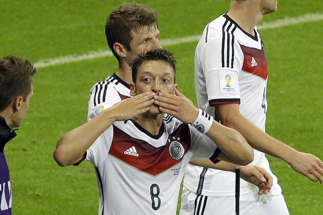 Germany's Mesut Ozil blows a kiss as he celebrates scoring his side's second goal during the World Cup round of 16 soccer match between Germany and Algeria at the Estadio Beira-Rio in Porto Alegre, Brazil, Monday, June 30, 2014. Germany beat Algeria 2-1 in extra time to set up World Cup quarterfinal match against France. (AP Photo/Thanassis Stavrakis)
