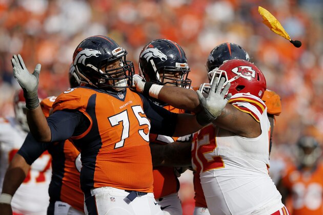FILE - In this Sept. 14, 2014, file photo, Denver Broncos tackle Chris Clark (75) and Kansas City Chiefs wide receiver Dwayne Bowe (82) push each other as a flag is thrown during the second half of an NFL football game in Denver. The NFL's emphasis on defensive-backfield penalties has contributed to an average of more than two extra flags every game this season, a 15 percent rise from 2013.   (AP Photo/Jack Dempsey, File)