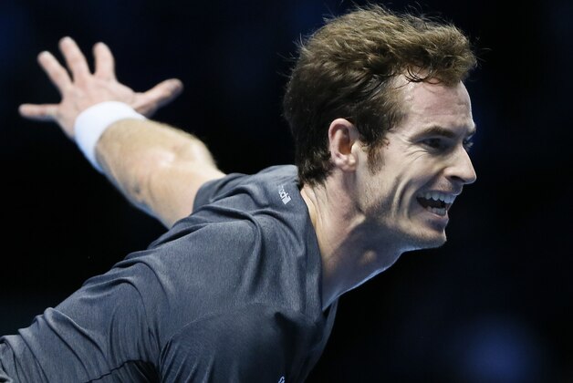 Britain’s Andy Murray serves to Switzerland’s Roger Federer during their singles ATP World Tour Finals tennis match at the O2 Arena in London, Thursday, Nov. 13, 2014. (AP Photo/Kirsty Wigglesworth)