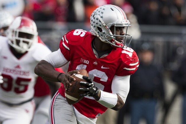 Nov 22, 2014; Columbus, OH, USA; Ohio State Buckeyes quarterback J.T. Barrett (16) looks downfield for an open receiver against the Indiana Hoosiers at Ohio Stadium. Ohio State won the game 42-27. Mandatory Credit: Greg Bartram-USA TODAY Sports