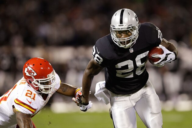 OAKLAND, CA - NOVEMBER 20:  Latavius Murray #28 of the Oakland Raiders fights off Sean Smith #21 of the Kansas City Chiefs as he runs the ball during the game at O.co Coliseum on November 20, 2014 in Oakland, California.  (Photo by Ezra Shaw/Getty Images)