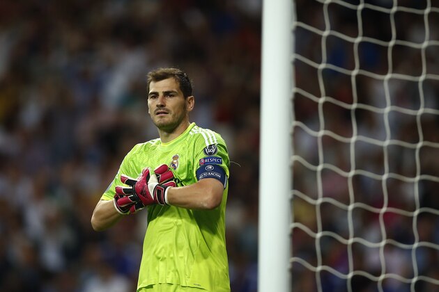 Real's Iker Casillas adjusts his gloves during the Champions League Group B soccer match between Real Madrid and Basel at the Santiago Bernabeu stadium in Madrid, Spain, Tuesday, Sept. 16, 2014. (AP Photo/Andres Kudacki)