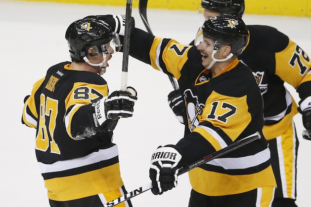 Pittsburgh Penguins' Blake Comeau (17)  celebrates his third goal of the game with Sidney Crosby (87) during the overtime period of an NHL hockey game against the Toronto Maple Leafs in Pittsburgh Wednesday, Nov. 26, 2014. The Penguins won 4-3 in overtime. (AP Photo/Gene J. Puskar)