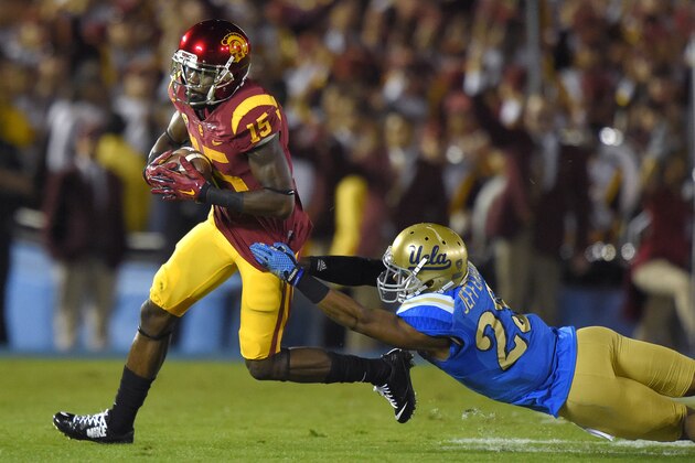 Southern California wide receiver Nelson Agholor, left, escapes a tackle by UCLA defensive back Anthony Jefferson during the first half of an NCAA college football game, Saturday, Nov. 22, 2014, in Pasadena, Calif. (AP Photo/Mark J. Terrill)