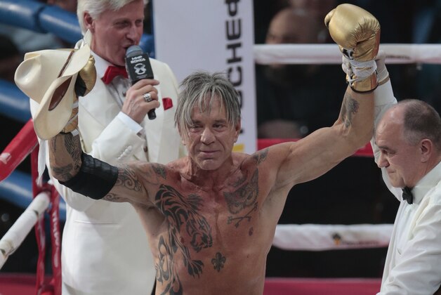 US actor Mickey Rourke celebrates his victory against his opponent Elliot Seymour of the United States, after their professional boxing match at the Luzhniki Stadium, Moscow, Friday, Nov. 28, 2014. Hollywood actor Mickey Rourke returned to the boxing ring Friday at the age of 62, defeating a fighter less than half his age in an exhibition bout. (AP Photo/Ivan Sekretarev)