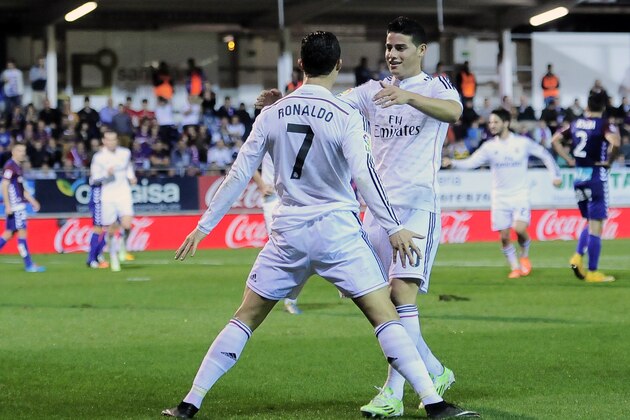 Real Madrid's Cristiano Ronaldo, front, celebrates with teammate James Rodriguez after scoring his goal against SD Eibar, during their La Liga soccer match, at Ipurua stadium in Eibar, northern Spain, Saturday Nov. 22, 2014. (AP Photo/Alvaro Barrientos)