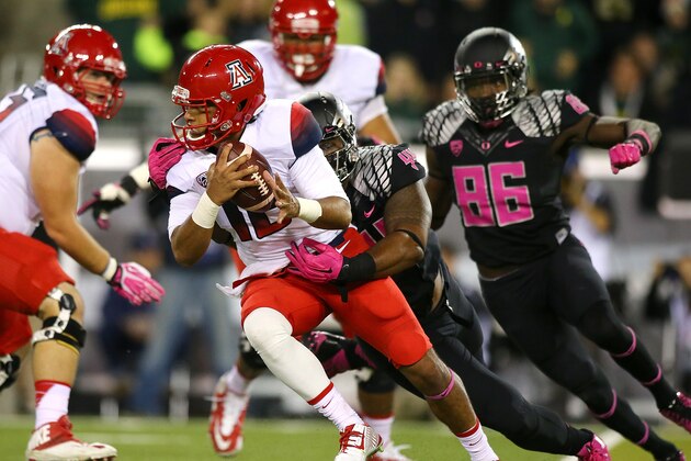 EUGENE, OR - OCTOBER 02: Anu Solomon #12 of the Arizona Wildcats is sacked by DeForest Buckner #44 of the Oregon Ducks at Autzen Stadium on October 2, 2014 in Eugene, Oregon. (Photo by Jonathan Ferrey/Getty Images)