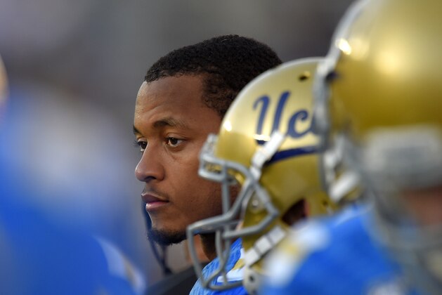 UCLA quarterback Brett Hundley, center, looks on after being taken out of the game late in the second half of an NCAA college football game against Stanford, Friday, Nov. 28, 2014, in Pasadena, Calif. Stanford won 31-10. (AP Photo/Mark J. Terrill)