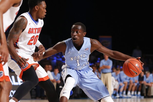 Nov 28, 2014; Paradise Island, BAHAMAS; North Carolina Tar Heels guard/forward Theo Pinson (1) dribbles as Florida Gators guard Michael Frazier II (20) defends during the first half at Imperial Arena at Atlantis Resort. Mandatory Credit: Kevin Jairaj-USA TODAY Sports