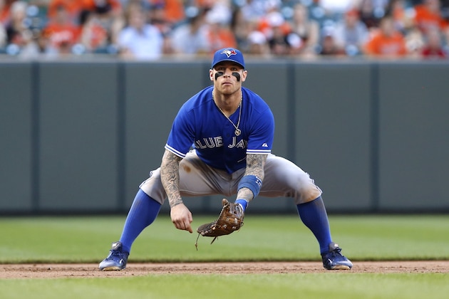 BALTIMORE, MD - JUNE 14: Infielder Brett Lawrie #13 of the Toronto Blue Jays takes over at third base in a defensive switch in the eighth inning during the game against the Baltimore Orioles at Oriole Park at Camden Yards on June 14, 2014 in Baltimore, Maryland. (Photo by Jonathan Ernst/Getty Images)