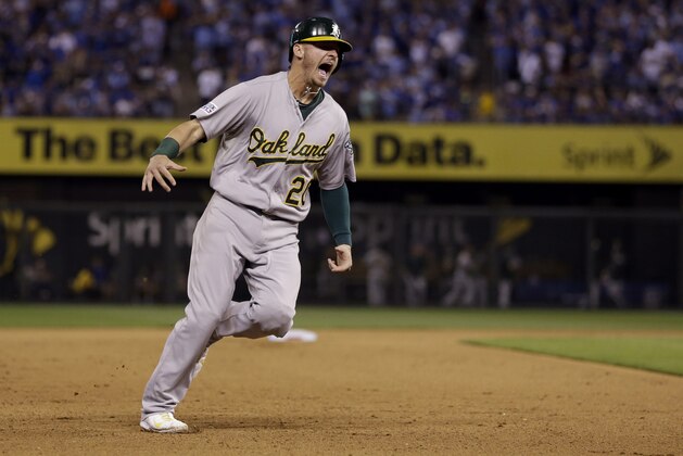 Oakland Athletics' Josh Donaldson celebrates as he rounds the bases on a three-run home run by teammate Brandon Moss during the sixth inning of the AL wild-card playoff baseball game against the Kansas City Royals Tuesday, Sept. 30, 2014, in Kansas City, Mo. The home run was Moss' second of the game. (AP Photo/Jeff Roberson)