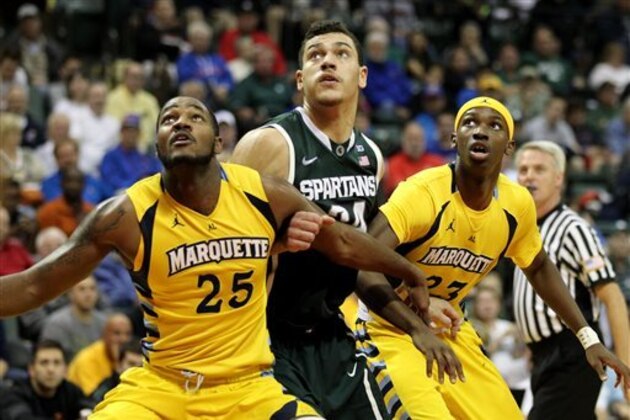 Marquette forward Steve Taylor Jr. (25) and guard JaJuan Johnson (23) box out Michigan State forward Gavin Schilling (34) during the first half of an NCAA college basketball game in Lake Buena Vista, Fla., Friday, Nov. 28, 2014. (AP Photo/Reinhold Matay)