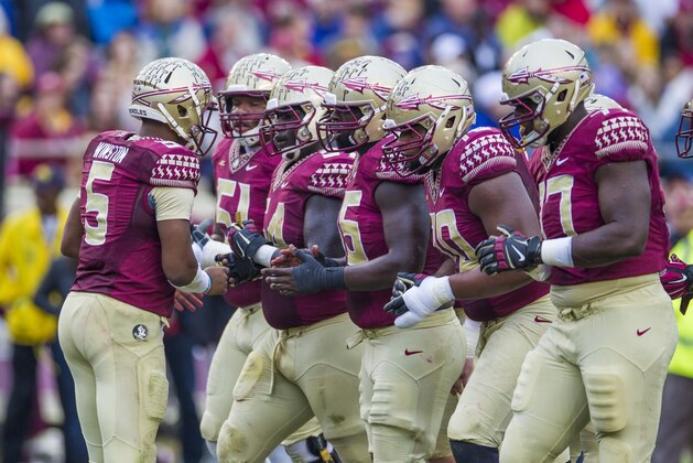 Florida State quarterback Jameis Winston calls a play in the huddle during the first half of an NCAA college football game against Boston College in Tallahassee, Fla., Saturday, Nov. 22, 2014.  Florida State defeated Boston College 20-17.  (AP Photo/Mark Wallheiser)
