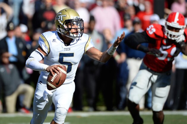 Georgia Tech quarterback Justin Thomas (5) runs out of the pocket under pursuit by Georgia defensive tackle Lamont Gaillard (53) during the first half of an NCAA college football game Saturday, Nov. 29, 2014, in Athens, Ga. (AP Photo/David Tulis)
