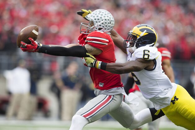 Nov 29, 2014; Columbus, OH, USA; Ohio State Buckeyes wide receiver Devin Smith (9) pulls in a pass in front of Michigan Wolverines defensive back Raymon Taylor (6) at Ohio Stadium. Mandatory Credit: Greg Bartram-USA TODAY Sports
