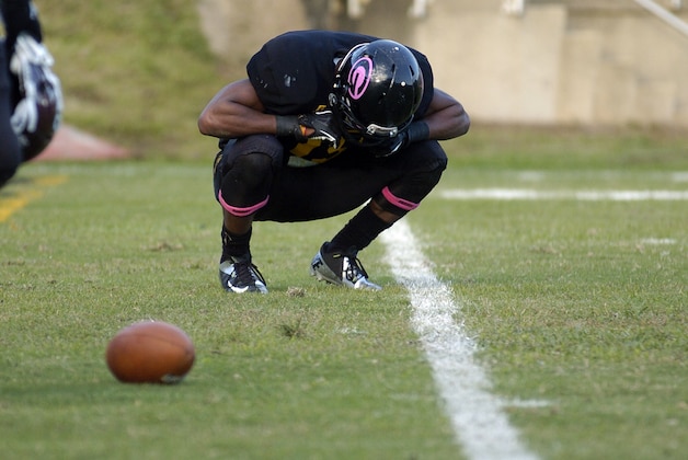 A Grambling State football player kneels in disappointment by the game ball after Texas Southern defeated Grambling 23-17 in an NCAA college football game in Grambling, La., Saturday, Oct. 26, 2013. The game came one week after the team forfeited a game in protest of its own university administration. (AP Photo/Kita Wright)