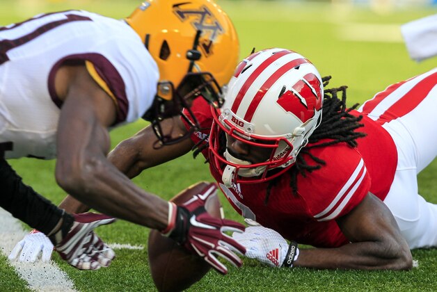 Minnesota's Eric Murray, left, recovers a fumble by Wisconsin's Kenzel Doe on a punt return during the first half of an NCAA college football game Saturday, Nov. 29, 2014, in Madison, Wis. (AP Photo/Andy Manis)