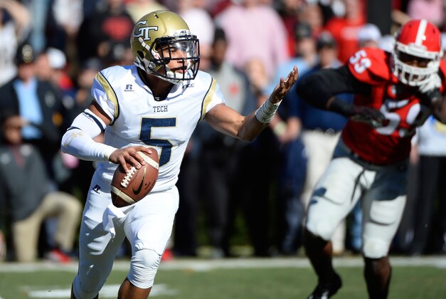 Georgia Tech quarterback Justin Thomas (5) runs out of the pocket under pursuit by Georgia defensive tackle Lamont Gaillard (53) during the first half of an NCAA college football game Saturday, Nov. 29, 2014, in Athens, Ga. (AP Photo/David Tulis)