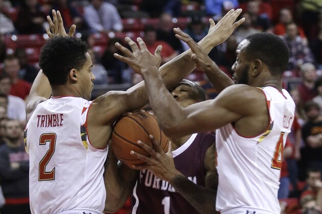 Fordham guard Mandell Thomas, center, collides with Maryland guard Melo Trimble, left, and guard/forward Dez Wells as he goes up for a shot during the first half of an NCAA college basketball game, Thursday, Nov. 20, 2014, in College Park, Md. (AP Photo/Patrick Semansky)